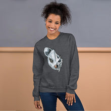Load image into Gallery viewer, A woman wears a unisex sweatshirt in the colour dark heather grey, printed with art of a split image: the left side features a possum&#39;s face, and the right side features an evil looking possum skull.
