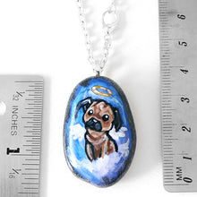 Load image into Gallery viewer, a beach stone pendant necklace, featuring dog art of a pug as an angel, next to two rulers to show its size:  1 7/16&quot; x 1&quot; or 3.6 cm x 2.5 cm
