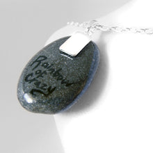 Load image into Gallery viewer, the back of a painted pug angel necklace, signed with &quot;rainbow of crazy&quot;
