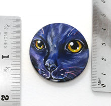 Load image into Gallery viewer, A wooden disc, with pet art of a cat, painted in purple and black, next to two rulers to show its size: 1 1/2&quot; or 3.8 cm across
