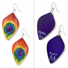 Load image into Gallery viewer, large, leaf shaped, wood fish hook earrings, hand painted with peacock feathers in rainbow colours: red on top, purple in the center, and purple on the back
