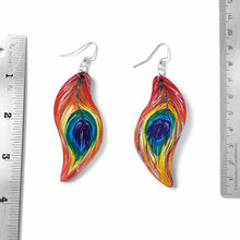 Load image into Gallery viewer, large, leaf shaped, wood fish hook earrings, hand painted with peacock feathers in rainbow colours
