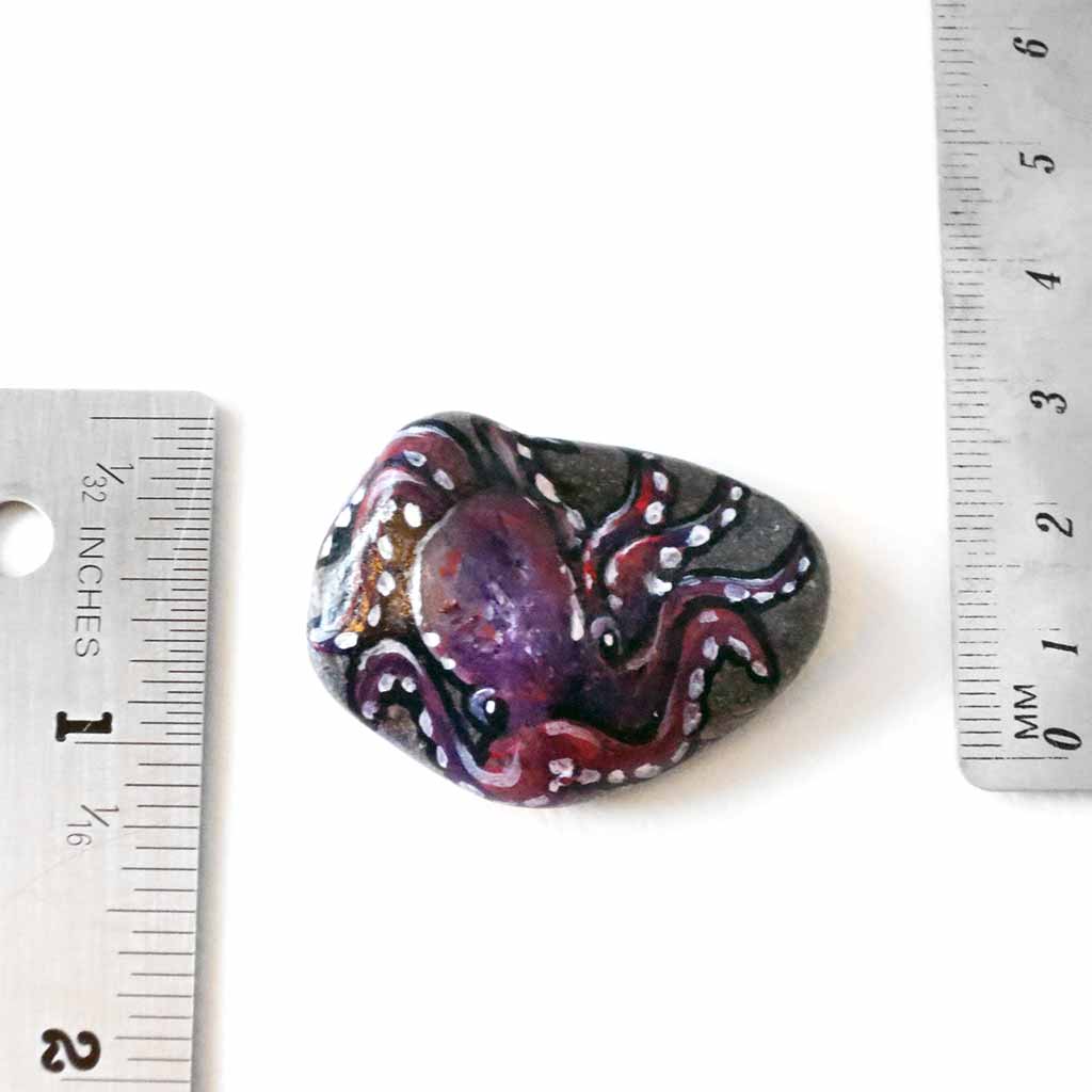 purple and pink octopus art, painted on a small beach stone, available as a keepsake or pendant necklace