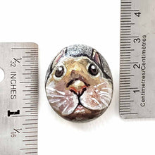 Load image into Gallery viewer, a small beach stone, hand painted with the fact of a creme d&#39;Argent rabbit, available as a keepsake or pendant necklace
