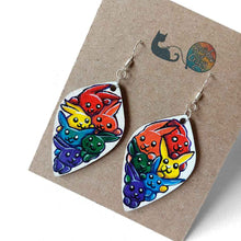 Load image into Gallery viewer, large, leaf shaped, wood earrings, hand painted with 6 cartoon style rabbits in every colour of the rainbow, against a white background.
