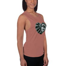 Load image into Gallery viewer, A woman is wearing the Raccoon Love Women&#39;s Muscle Tank Top, in the colour mauve, which is printed with a graphic of a raccoon forming the shape of a heart.
