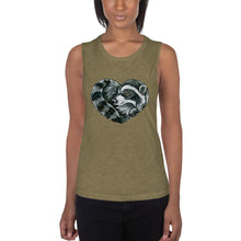 Load image into Gallery viewer, A woman is wearing the Raccoon Love Women&#39;s Muscle Tank Top, in the colour olive green, which is printed with a graphic of a raccoon forming the shape of a heart.
