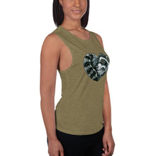 Load image into Gallery viewer, A woman is wearing the Raccoon Love Women&#39;s Muscle Tank Top, in the colour olive green, which is printed with a graphic of a raccoon forming the shape of a heart.
