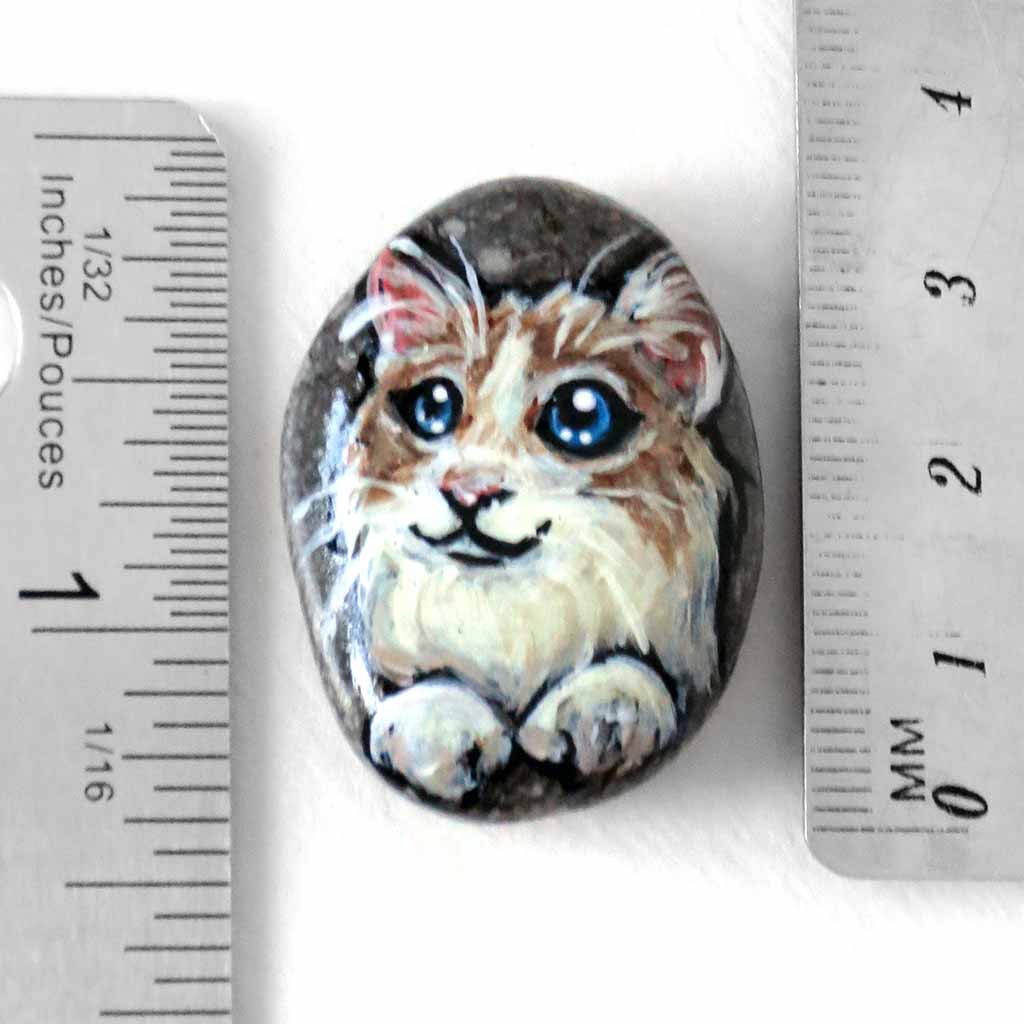 a beach stone, hand painted with a ragdoll cat, available as a rock art keepsake, or pendant necklace