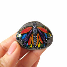 Load image into Gallery viewer, This small rock art features a butterfly painted with all the colours of the rainbow
