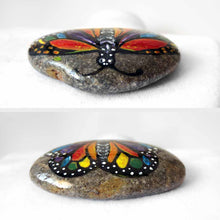 Load image into Gallery viewer, This small rock art features a butterfly painted with all the colours of the rainbow
