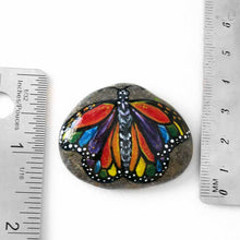 Load image into Gallery viewer, This small rock art features a butterfly painted with all the colours of the rainbow
