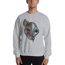 Load image into Gallery viewer, A man is wearing a unisex sweatshirt in the colour sport grey, which is printed with a split graphic: the left side features the face of a brown rat, and the right side features an evil looking rat skull
