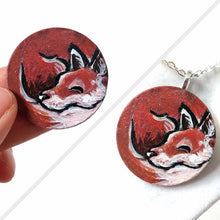 Load image into Gallery viewer, a small wood circle, hand painted with art of a red fox, curled up, sleeping. this piece is available as a keepsake or pendant necklace
