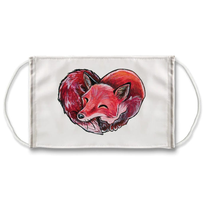 A reuseable white face mask, printed with art of a red fox sleeping, in a shape of a heart.
