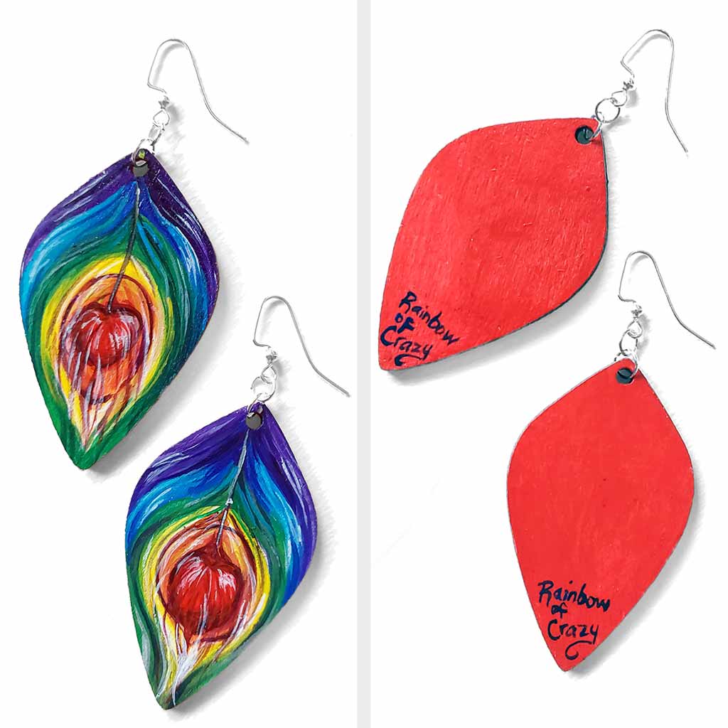 large, leaf shaped, wood fish hook earrings, hand painted with peacock feathers in rainbow colours: purple on top, red in the center, and red on the back