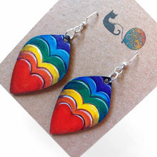 Load image into Gallery viewer, leaf shaped, wood fish hook earrings, hand painted with a red heart in front and hearts in rainbow colours behind
