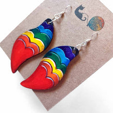 Load image into Gallery viewer, large, long, leaf shaped, wood fish hook earrings, hand painted with a red heart in front and hearts in rainbow colours rising above
