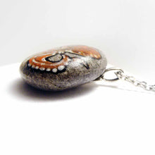 Load image into Gallery viewer, a small beach stone hand painted with art of a red octopus, available as a keepsake rock art, or as a pendant necklace
