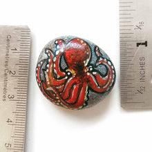 Load image into Gallery viewer, a small beach stone hand painted with art of a red octopus, available as a keepsake rock art, or as a pendant necklace
