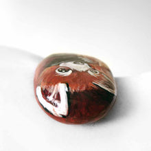 Load image into Gallery viewer, rock art, hand painted with a red panda hugging its tail
