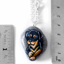 Load image into Gallery viewer, small beach stone, hand painted with art of a rottweiler dog
