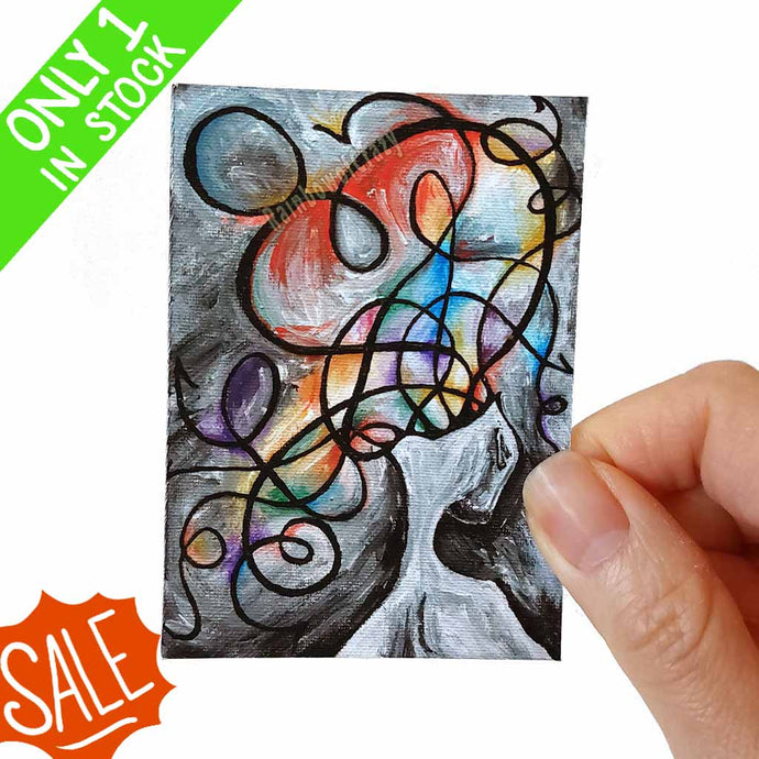 an aceo art print, featuring an abstract, surreal illustration of a person's head opening up into swirls of colours and lines and madness