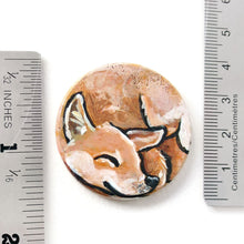 Load image into Gallery viewer, A circle wood disc painted with a portrait of a Shiba Inu dog having a nap, available as a keepsake, fridge magnet,
 or necklace
