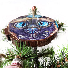 Load image into Gallery viewer, A wood ornament with art of a Siamese cat with blue eyes
