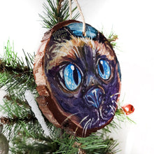 Load image into Gallery viewer, A Christmas ornament with a painting fo a blue eyed Siamese cat&#39;s face
