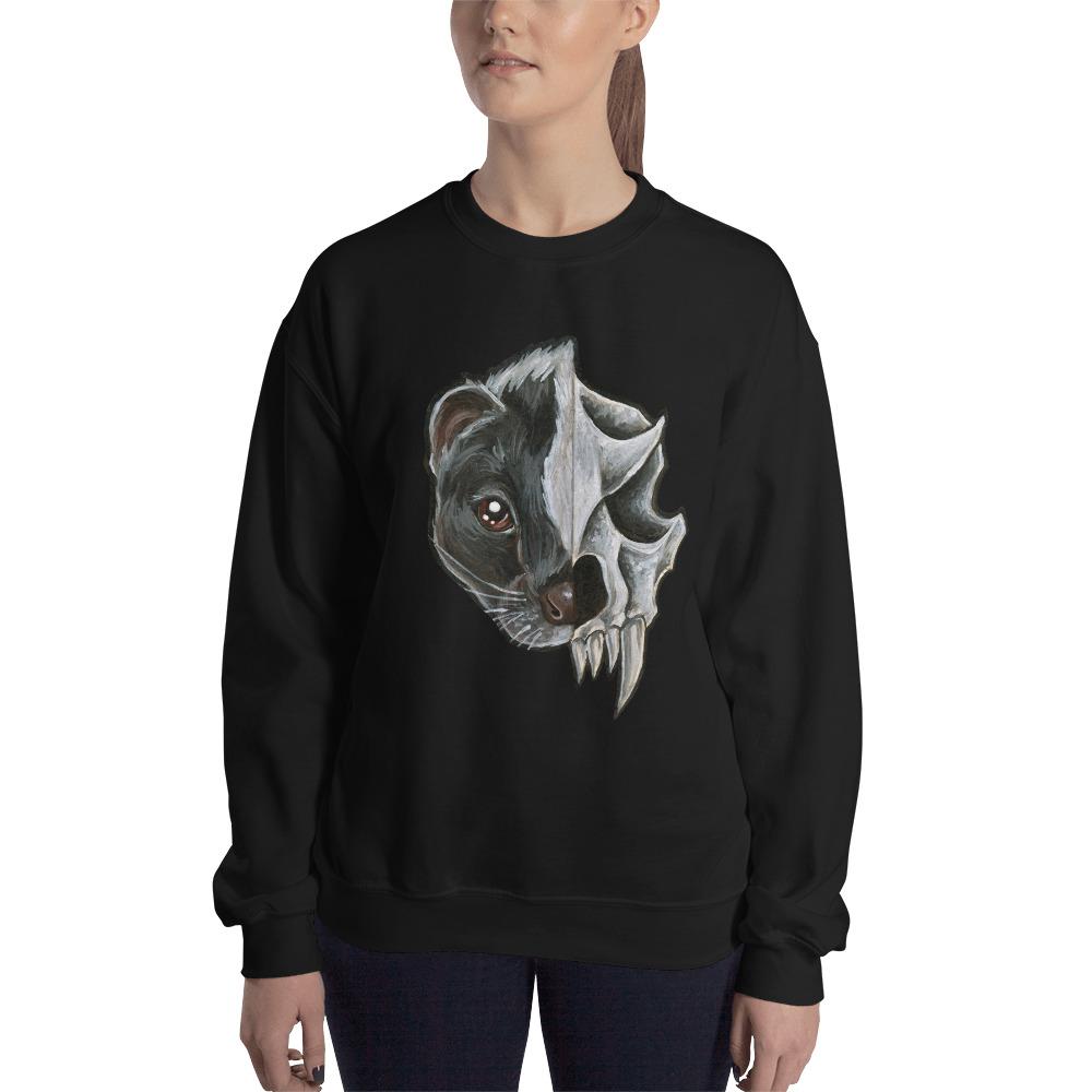 A woman wears a unisex sweatshirt in the colour black, printed with an image of a split portrait: the left side features the face of a skunk, and the right side features an evil looking skunk skull