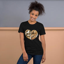 Load image into Gallery viewer, A woman is wearing the Sloth Love Unisex Premium T-Shirt in the colour black heather, which includes an illustration of a sloth forming the shape of a heart.
