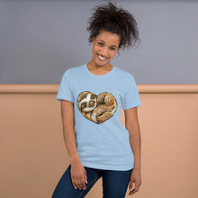 Load image into Gallery viewer, A woman is wearing the Sloth Love Unisex Premium T-Shirt in the colour light blue, which includes art of a sloth forming the shape of a heart.
