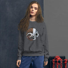 Load image into Gallery viewer, A woman wears a unisex sweatshirt in the colour dark heather grey, printed with a graphic of a split image: the left side features a sloth&#39;s face, and the right side features an evil looking sloth skull.
