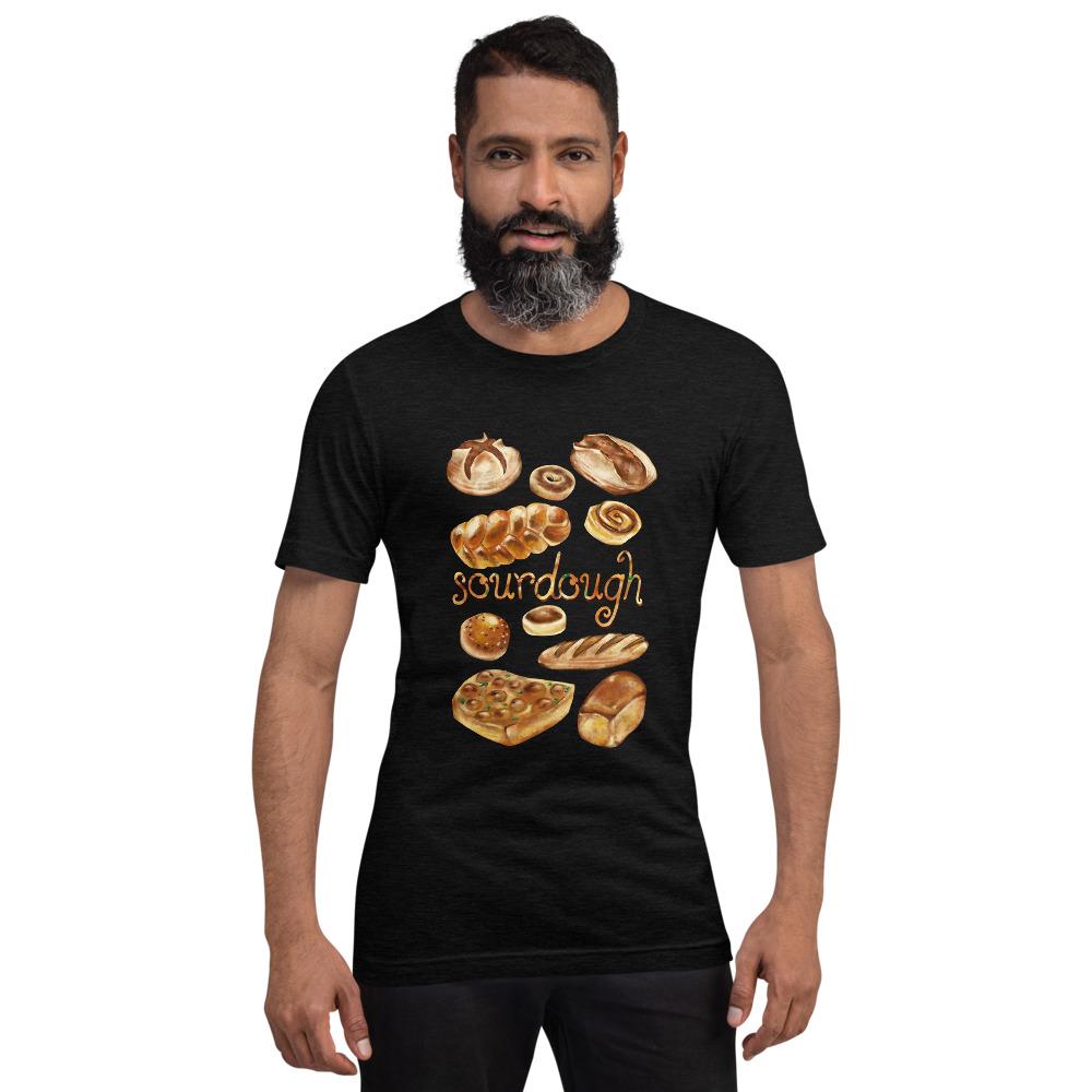 A man is wearing the Sourdough Lovers unisex premium t-shirt in the colour black heather, printed with artwork of 10 different sourdough breads.