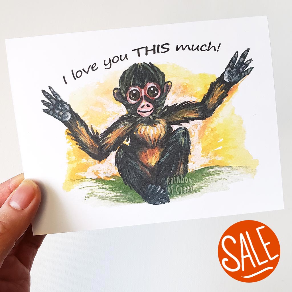 A greeting card with art of a spider monkey with arms stretrched out. The card reads, 