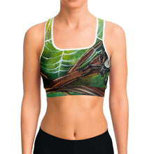 Load image into Gallery viewer, A woman wearing sports bra printed with an illustration of an orb weaver spider in front of its spider web.
