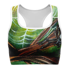 Load image into Gallery viewer, A sports bra printed with art of an orb weaver spider in front of its spider web.
