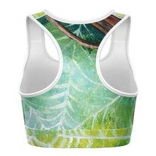 Load image into Gallery viewer, A sports bra printed with art of an orb weaver spider in front of its spider web.
