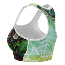 Load image into Gallery viewer, A sports bra printed with art of an orb weaver spider in front of its spider web.
