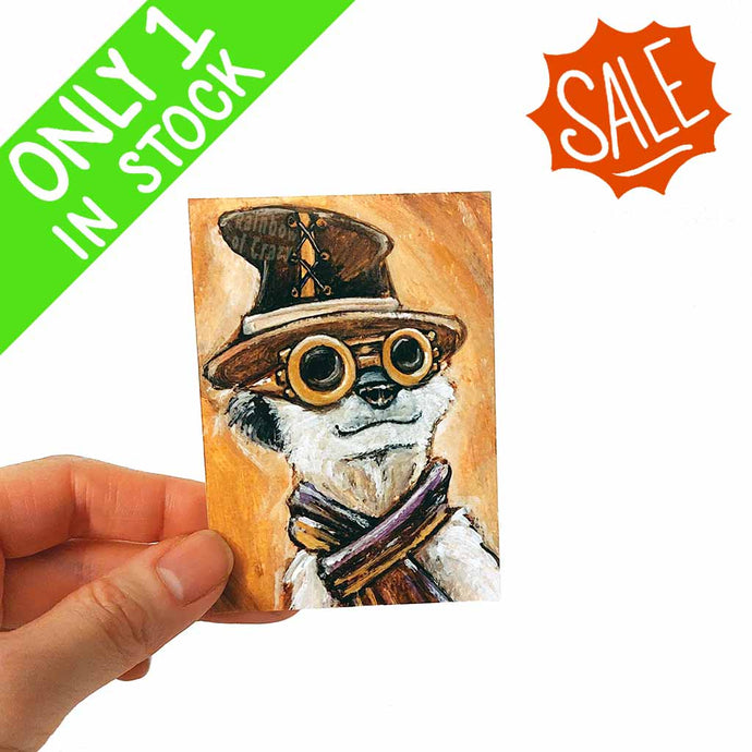 an aceo featuring a meerkat wearing a top hat, scarf, and steampunk glasses