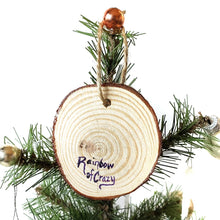 Load image into Gallery viewer, The back of a tree ornament, signed with, Rainbow of Crazy
