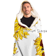 Load image into Gallery viewer, a man wears a white microfiber fleece hooded blanket, lined with premium sherpa, printed with sunflower art, with a black cat and white cat peeking out from the flowers
