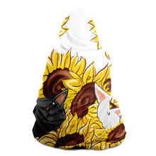 Load image into Gallery viewer, a man wears a white microfiber fleece hooded blanket, printed with sunflower art, with a black cat and white cat peeking out from the flowers
