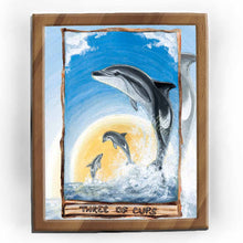 Load image into Gallery viewer, This art print features the Three of Cups tarot card from the Animism Tarot: three dusky dolphins jump out of the ocean, enjoying the warmth of the sun together.
