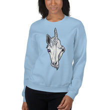 Load image into Gallery viewer, A woman is wearing a unisex sweatshirt in the colour light blue, which is printed with a split graphic: the left side features the face of a unicorn, and the right side features an evil looking skull
