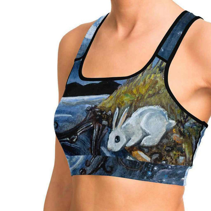 a woman wearing a sports bra printed with art of the Moon Tarot card, from the Animism Tarot deck.