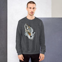 Load image into Gallery viewer, A man wears a unisex sweatshirt in the colour dark heather grey, printed with artwork of a split image: the left side features a wolf&#39;s face, and the right side features an evil looking wolf skull.
