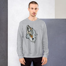 Load image into Gallery viewer, A man wears a unisex sweatshirt in the colour sport grey, printed with a graphic of a split image: the left side features a wolf&#39;s face, and the right side features an evil looking wolf skull.
