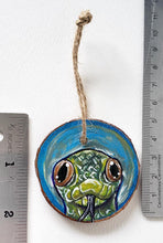 Load image into Gallery viewer, A Christmas tree wood ornament, hand painted with art of a yellow anaconda snake
